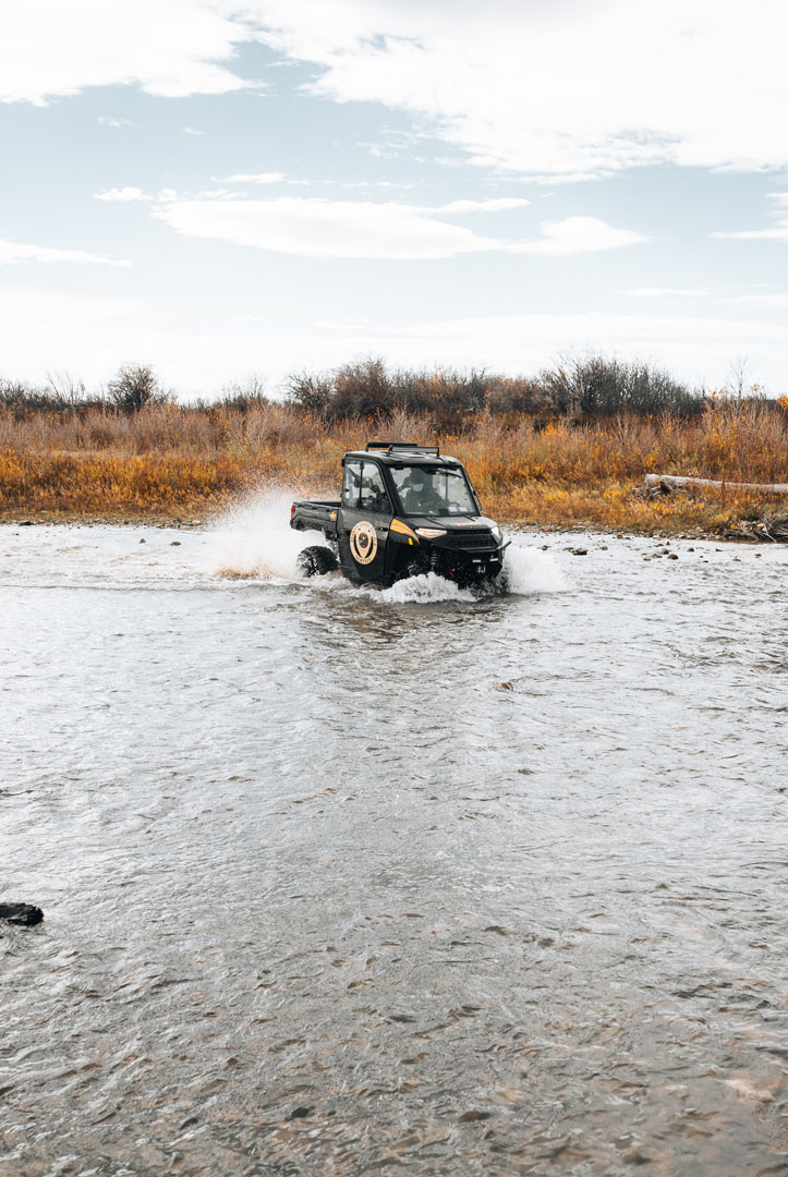 Blood Tribe Police vehicle driving through a river